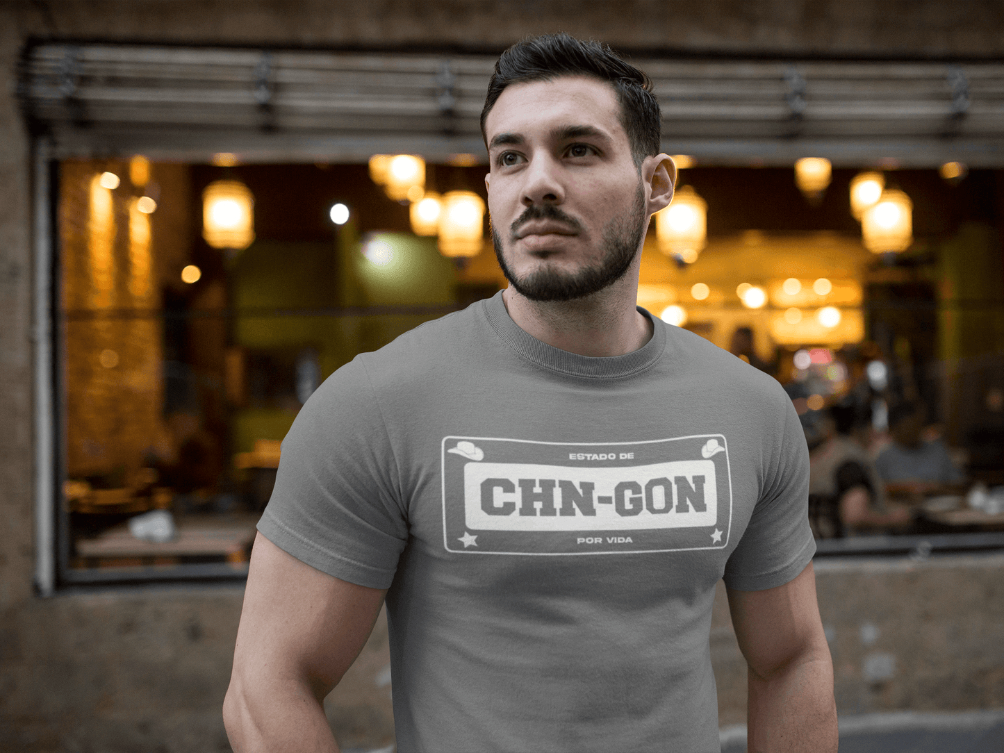Gray t-shirt with the text, "Estado de CHN-GON Por Vida" in white ink in a license plate layout. This shirt comes in sizes small thru 4XL. It is available at www.sanchezhere.com