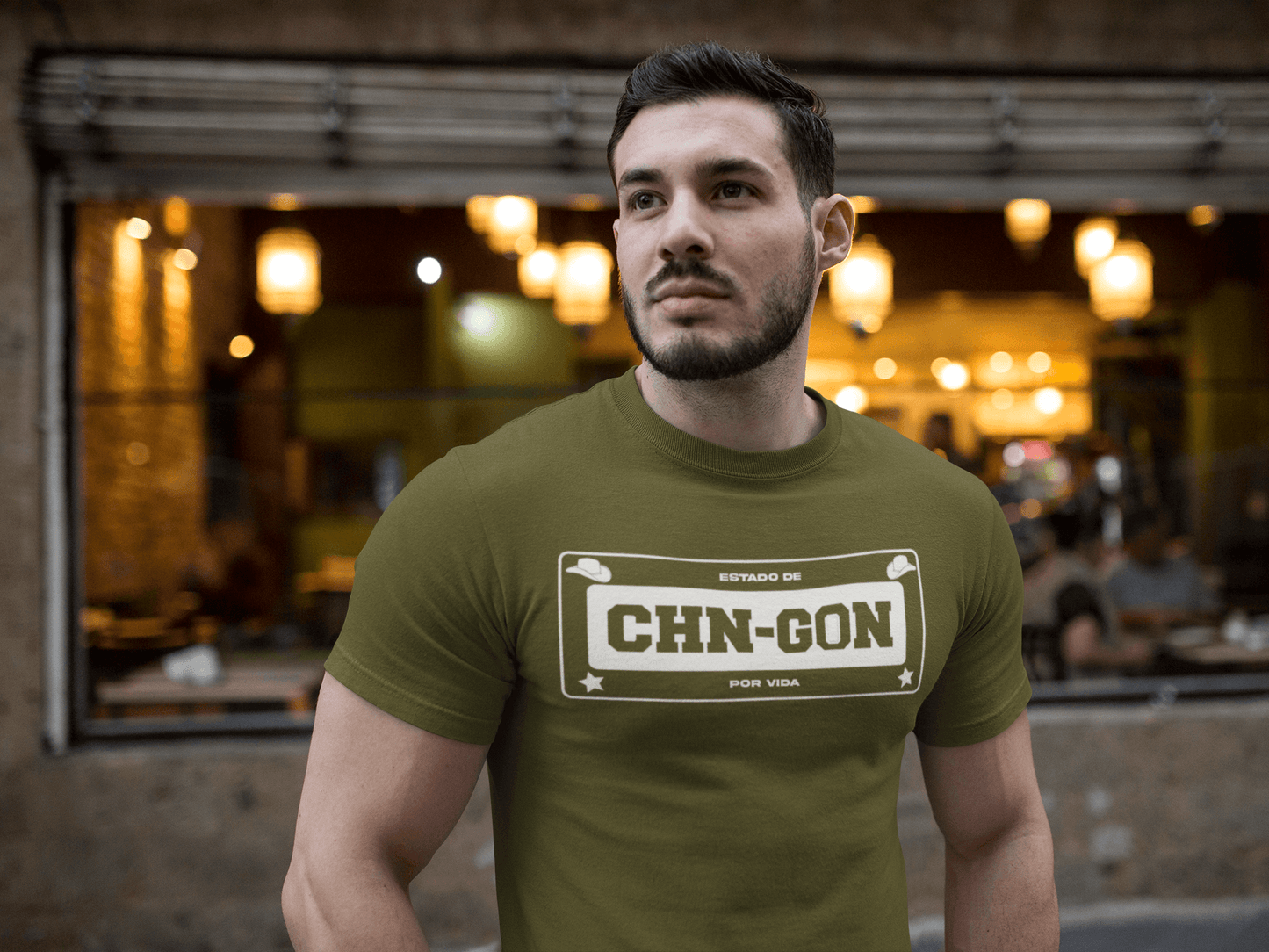 Green t-shirt with the text, "Estado de CHN-GON Por Vida" in white ink in a license plate layout. This shirt comes in sizes small thru 4XL. It is available at www.sanchezhere.com