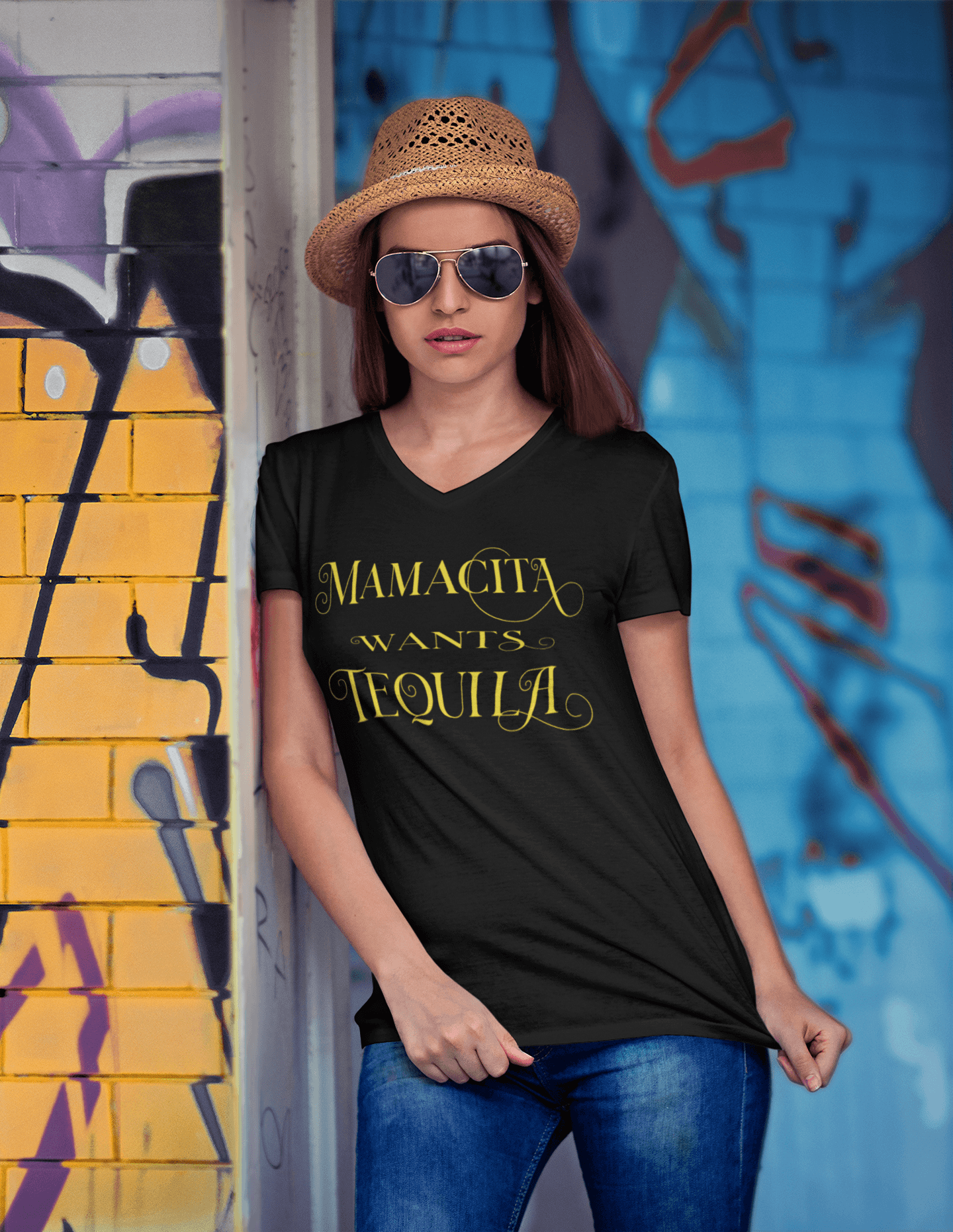 Black V-neck t-shirt with the text, "Mamacita Wants Tequila" in scriptive font and yellow ink. This sexy tee comes in sizes small thru 3XL. It is available at www.sanchezhere.com