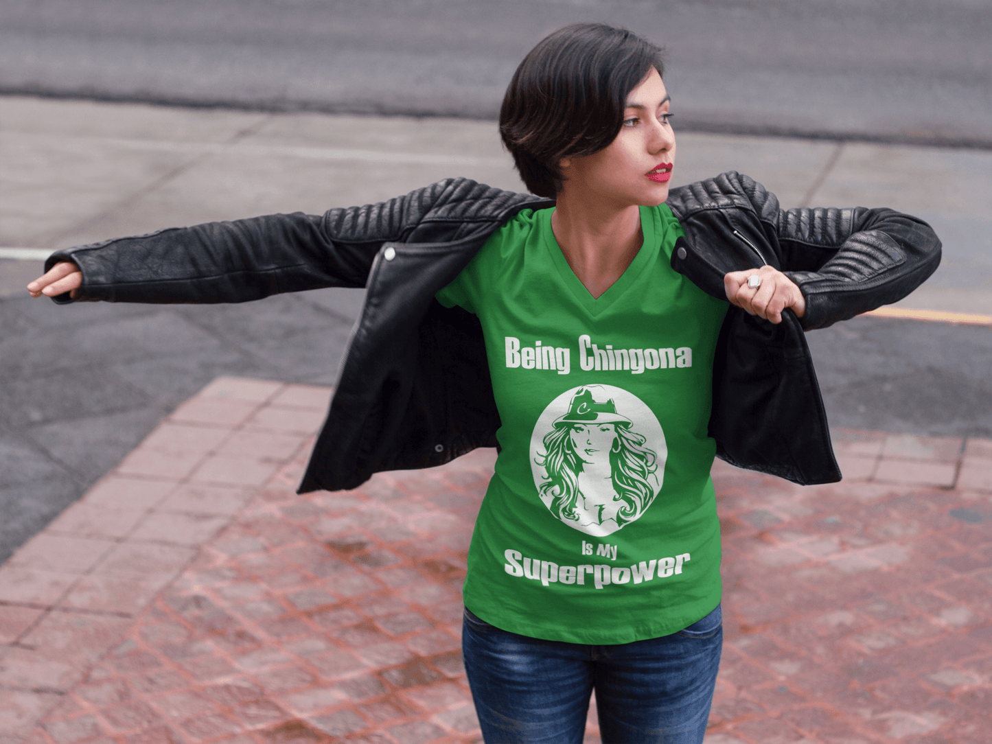 Ladies Green V-neck t-shirt with white lettering of "Being Chingona Is My Superpower" .