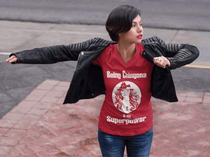 Ladies Red V-neck t-shirt with white lettering of "Being Chingona Is My Superpower" .