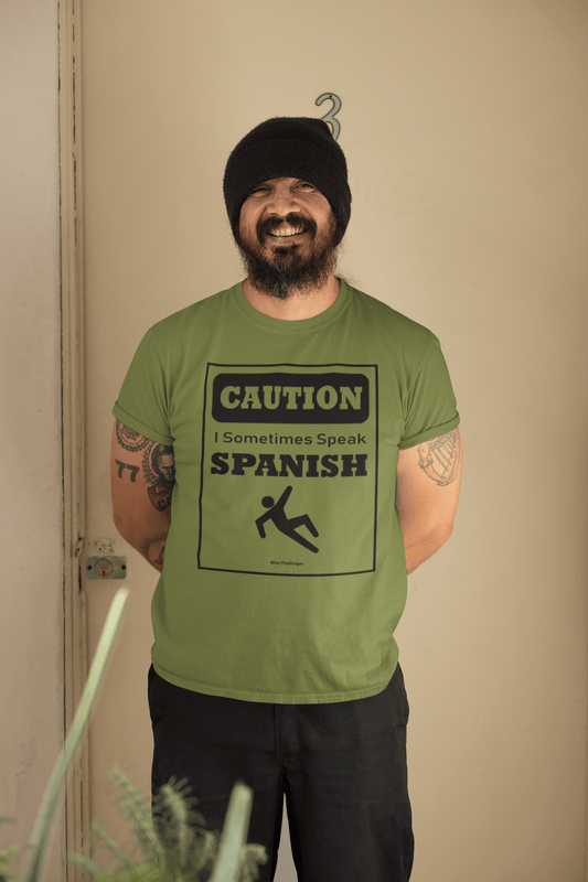 Army Green t-shirt with black text and design that reads, "Caution I sometimes speak Spanish #Don'tTripGringos " in a caution sign layout. It is available in sizes SM-4XL at www.sanchezhere.com