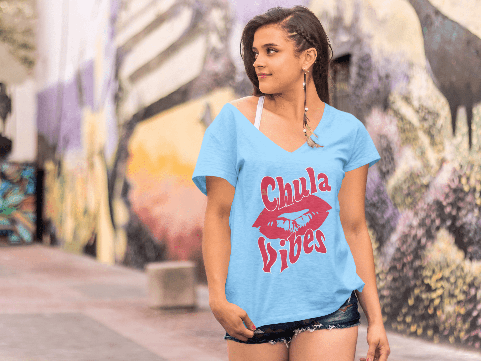 Teal V-neck t-shirt with the text, "Chula Vibes" in red ink and an image of lips. This cute tee comes in sizes small thru 3XL. It is available at www.sanchezhere.com
