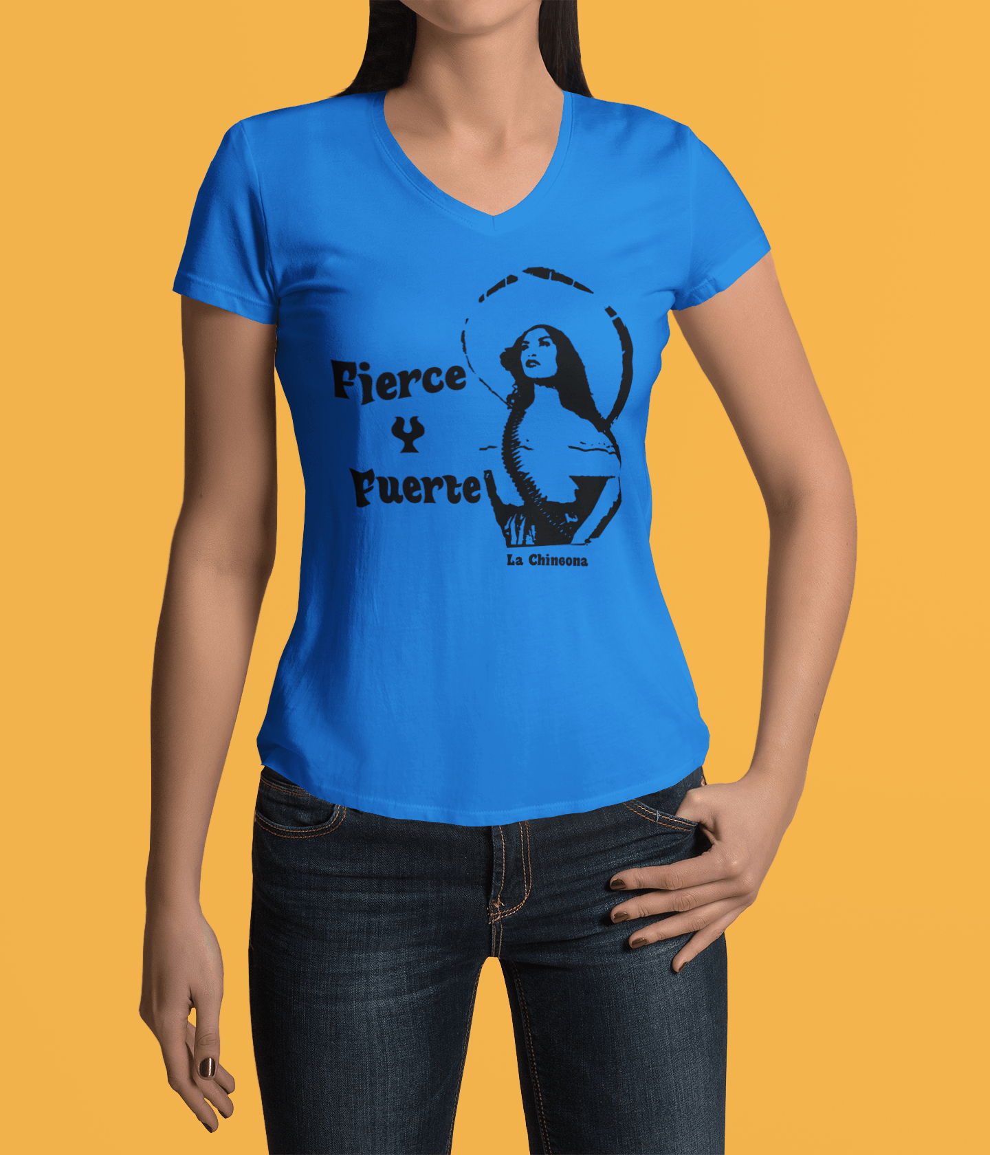 Blue V-neck t-shirt with the text, "Fierce Y Fuerte La Chingona" in black ink and a Mexican woman with a sombreo and bullet strap also in black ink. This sassy tee comes in sizes small thru 3XL. It is available at www.sanchezhere.com