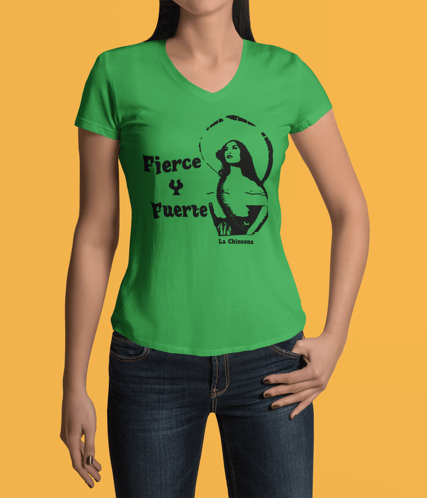 Green V-neck t-shirt with the text, "Fierce Y Fuerte La Chingona" in black ink and a Mexican woman with a sombreo and bullet strap also in black ink. This sassy tee comes in sizes small thru 3XL. It is available at www.sanchezhere.com