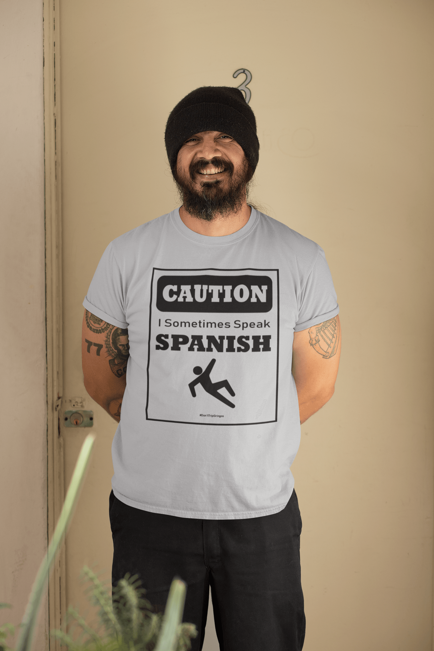 Gray t-shirt with black text and design that reads, "Caution I sometimes speak Spanish #Don'tTripGringos " in a caution sign layout. It is available in sizes SM-4XL at www.sanchezhere.com