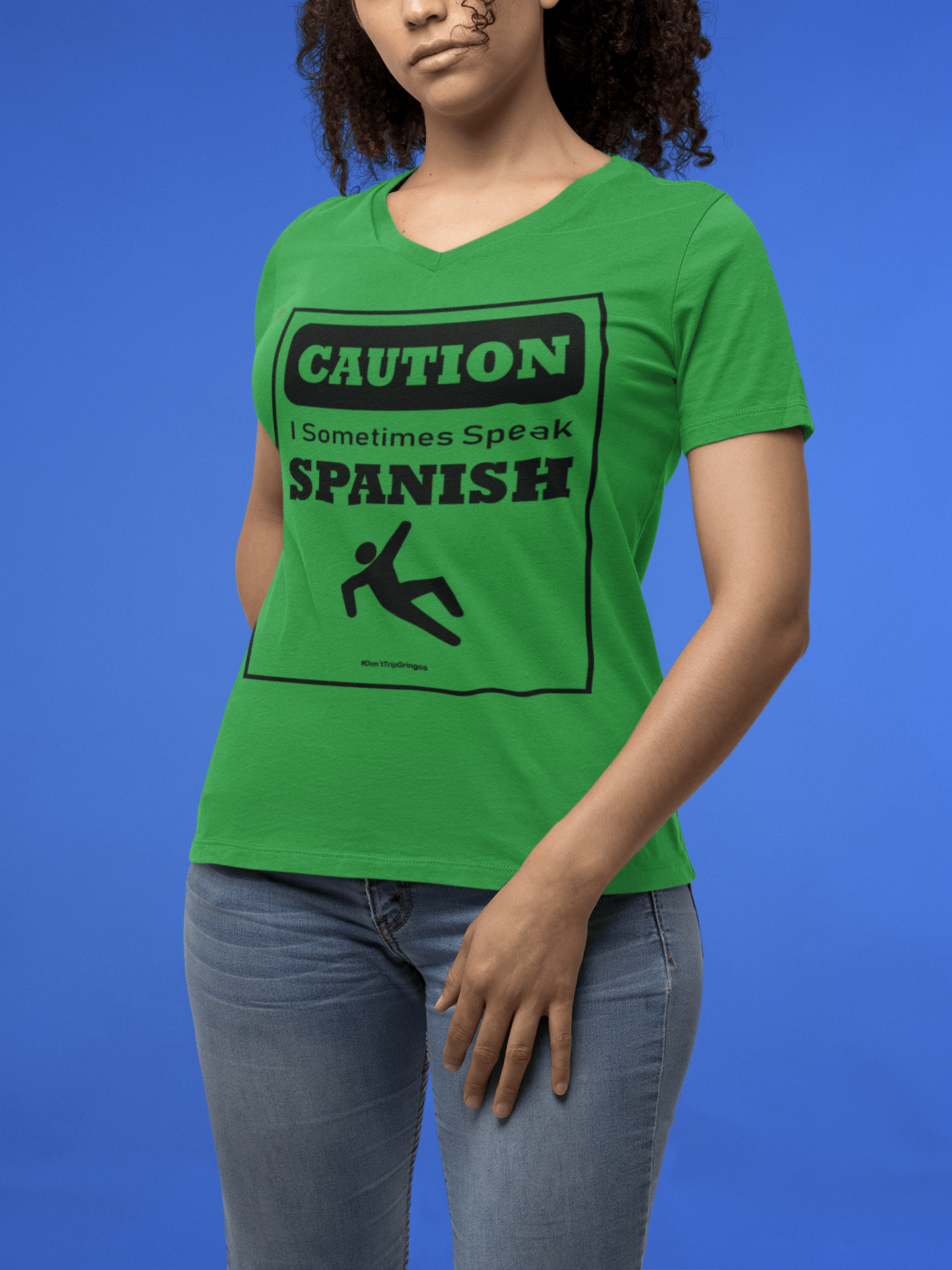 Green V-Neck t-shirt with black text and design that reads, "Caution I sometimes speak Spanish #Don'tTripGringos " in a caution sign layout. It is available in sizes SM-3XL at www.sanchezhere.com