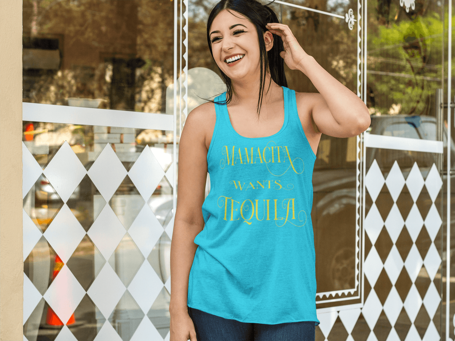 Teal racerback tank with the text, "Mamacita Wants Tequila" in scriptive font and yellow ink. This sexy tee comes in sizes small thru 3XL. It is available at www.sanchezhere.com