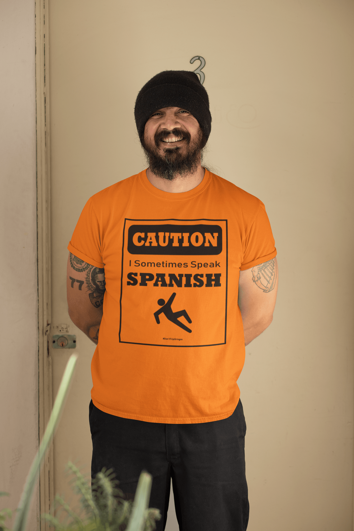 Bright orange t-shirt with black text and design that reads, "Caution I sometimes speak Spanish #Don'tTripGringos " in a caution sign layout. It is available in sizes SM-4XL at www.sanchezhere.com