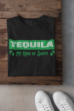 Load image into Gallery viewer, Black Unisex T-shirt with the text, Tequila My Kind of shots, and a picture of two shot glasses in lime green ink. This tee comes in sizes small-3xl and is available at www.sanchezhere.com