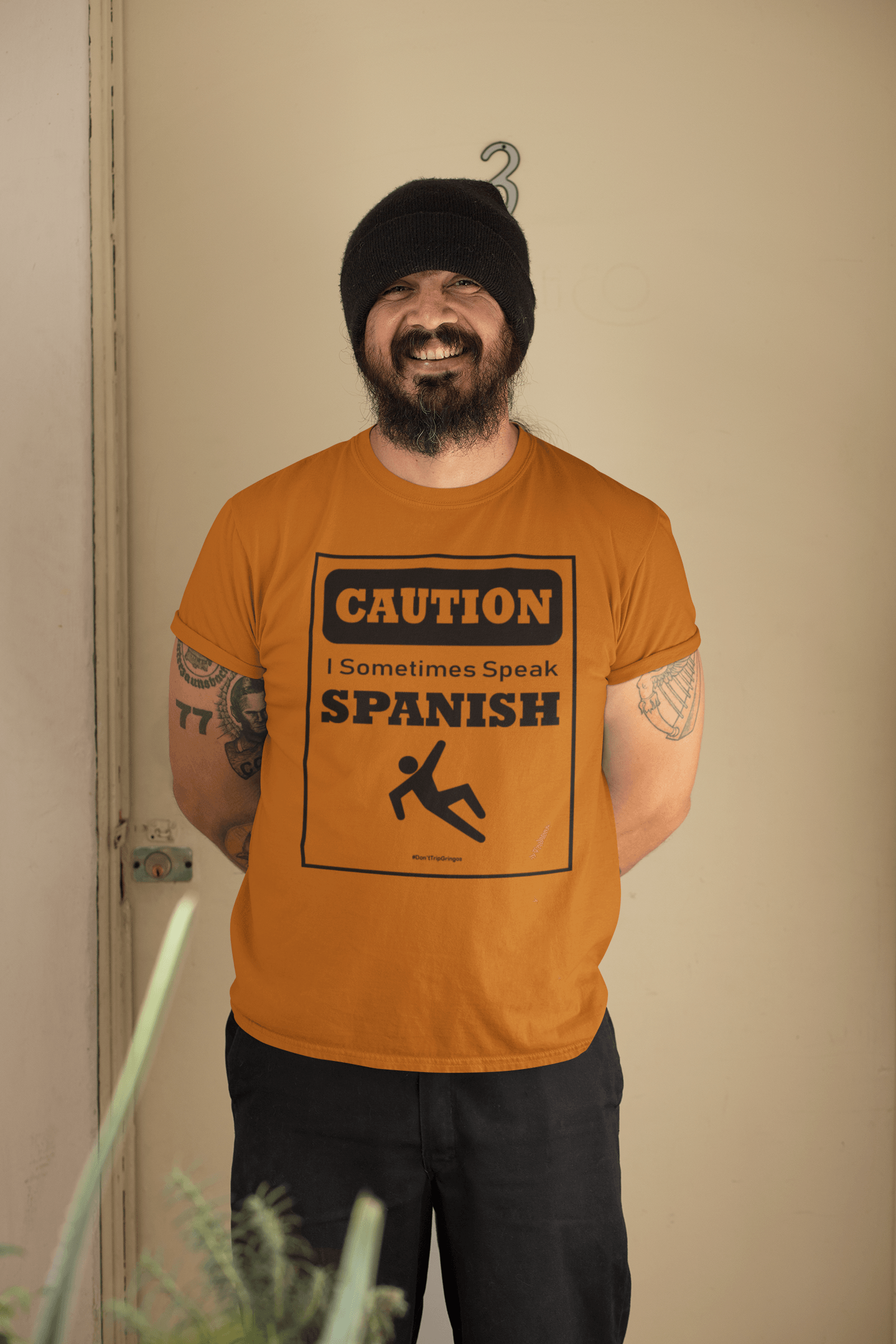 Texas orange t-shirt with black text and design that reads, "Caution I sometimes speak Spanish #Don'tTripGringos " in a caution sign layout. It is available in sizes SM-4XL at www.sanchezhere.com