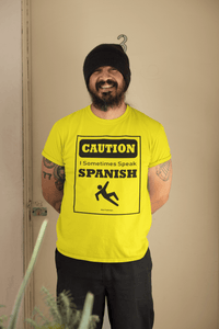 Bright Yellow t-shirt with black text and design that reads, "Caution I sometimes speak Spanish #Don'tTripGringos " in a caution sign layout. It is available in sizes SM-4XL at www.sanchezhere.com